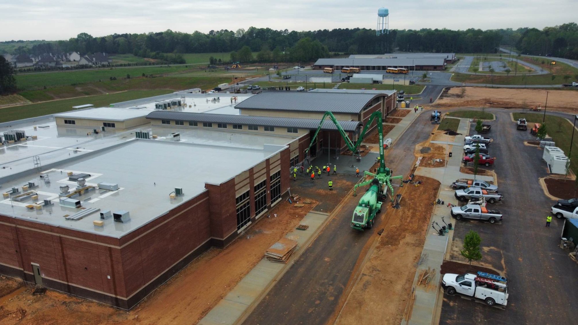 Aerial view of Dove Creek Elementary School under construction with concrete pump placing the entry plaza
